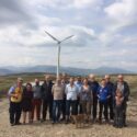 Members of Heartland Community Wind in front of wind turbine